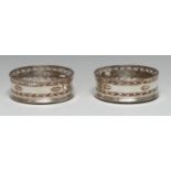 A pair of George III Old Sheffield Plate circular wine coasters, pierced with navette shaped