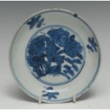 A 17th century Chinese circular dish, painted in tones of underglaze blue with chrysanthemums,