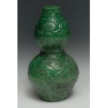 A Chinese double gourd vase, monochrome green glaze, decorated in relief with dragon, 33cm high