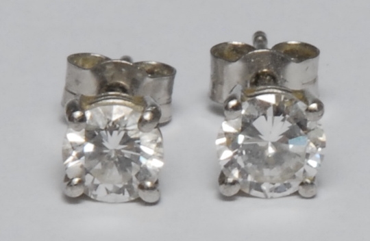 A pair of brilliant cut diamond stud earrings, mounted in platinum, AnchorCert, total diamond weight