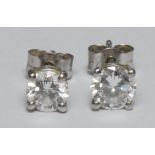 A pair of brilliant cut diamond stud earrings, mounted in platinum, AnchorCert, total diamond weight