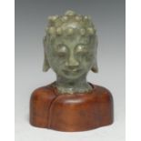 A Chinese jade sculptural fragment, carved as the head of Buddha, 11.5cm high, 19th century or