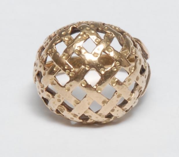 A gold coloured metal ring, domed lattice plateau, ring size Q, 6g