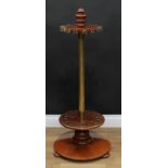 A Victorian brass and mahogany revolving snooker cue stand, turned urnular finial above an