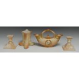 A pair of Royal Worcester boudoir candlesticks, in relief with cartouches and swags, 11.5cm high,
