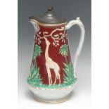 A Victorian Gothic Revival stoneware jug, moulded in relief with giraffes and leafy palms on a