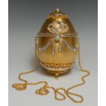 A lady's evening bag, as a gold egg, set with faux diamonds and pearls, 8cm high