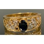 A sapphire and diamond ring, raised quarter claw set deep blue oval sapphire approx 0.45ct above