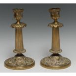A pair of post-Regency gilt brass table candlesticks, fluted pillars, cast throughout with acanthus,