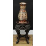 A Chinese hardwood jardiniere stand, circular top with inset soapstone panel, above a deep frieze