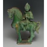 A Chinese equestrian figure, modelled in the Tang manner as a warrior on horseback, glazed in