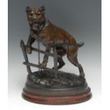 A 19th century brown patinated animalier model, of a chained dog, after Charles Valton, oval