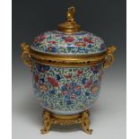 An ormolu mounted Chinese jar and cover, brightly painted in polychrome with flowers and scrolling
