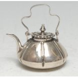 An 18th century Dutch silver miniature toy kettle, 6cm over shaped swing handle, c.1775