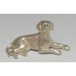 A cast silver model of a dog, 9cm wide, marked SIL, 7.5oz