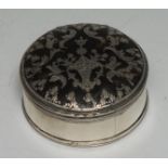 An 18th century silver, tortoiseshell and pique circular table snuff box, hinged cover inlaid with a