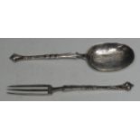 An 18th century Italian silver spoon and three-prong fork, the scroll-end stems cast with masks, the