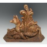 A Victorian cast iron door stop, cast as a fox, seated amongst scrolling leaves, canted base, 34cm