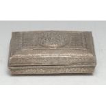 A Tibetan silver rectangular box, profusely chased and engraved with lotus and bands of trellis,