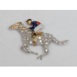 An 18ct white gold, diamond and enamel novelty brooch, as a horse and jockey, at full gallop, 4cm