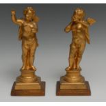 A pair of 19th century gilt metal cherubs, Allegorical of Music, each standing, one with a