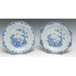 A pair of Chinese porcelain octagonal plates, painted with a bird on a blossoming branch, winged