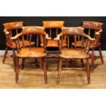 A composed set of five Victorian smoker's bow elbow chairs, each with a curved cresting rail,