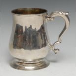 A George II silver bell shaped mug, acanthus-capped double-scroll handle, skirted base, gilt