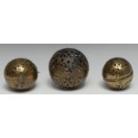 A 19th century Indian brass rolling lamp, hand warmer or incense ball, pierced and engraved in the