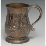 A George II silver baluster mug, repoussé chased with fruiting vine, ripe fruits and blossoming