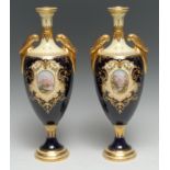 A pair of Coalport slender pedestal ovoid vases, decorated with an oval vignettes with landscape,