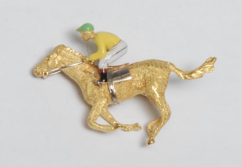 An 18ct gold, diamond and enamel novelty brooch, as a horse and jockey, at full gallop, 4cm long,