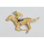 An 18ct gold, diamond and enamel novelty brooch, as a horse and jockey, at full gallop, 4cm long,
