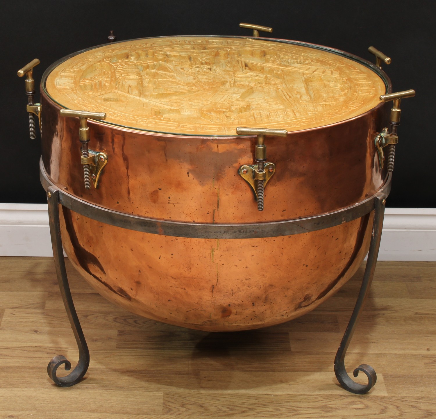 An Arts & Crafts copper timpani kettle, stamped Potter, London, the aperture anachronistically set