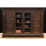 A substantial late 19th century Continental library bookcase, outswept cornice above a deep frieze