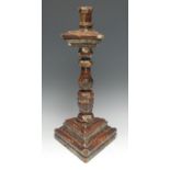 A 17th century North European softwood and gesso triform candlestick, turned pillar, 46cm high, c.