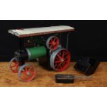 A Mamod TE1A live steam tractor, green body with cream canopy, red spoked wheels and flywheel,