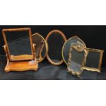 Mirrors - a Victorian dressing table mirror, 71.5cm high; an oval gilt framed mirror, ribbon