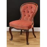 A Victorian mahogany spoon back drawing room side chair, stuffed-over upholstery, carved cabriole