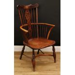 A country house ash and elm Windsor elbow chair, shaped cresting rail above a wheel back splat,