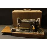 A Singer electric sewing machine, serial number EE663192, carry case