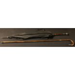 An early 20th century silver mounted palmwood walking stick; an Edwardian silver mounted umbrella,