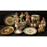 A continental porcelain figure; a musical Pierrot doll; a resin figure; others; a Staffordshire