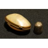 A 19th century mother of pearl ovoid thimble case, containing hallmarked silver thimble,