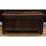 A 17th century oak blanket chest, hinged four panel top enclosing a vacant interior, the frieze