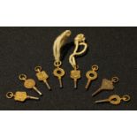 A collection of eight advertising pocket watch keys