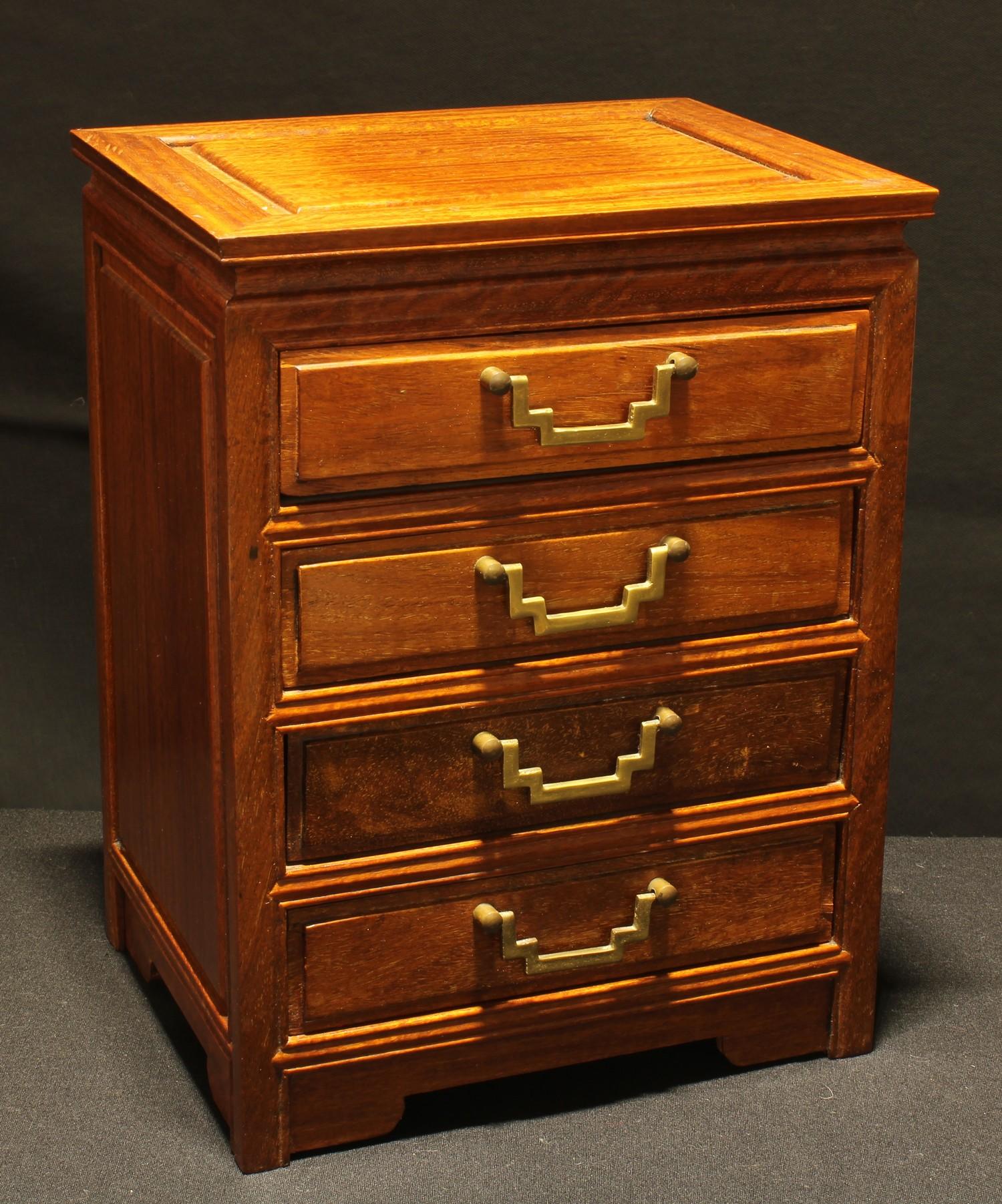 A Chinese hardwood table top chest, rectangular panelled top above four drawers, brass handles, 33.