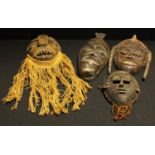 Tribal Art - an African carved wooden wall mask, three others similar (4)