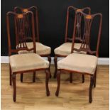 A set of four early 20th century mahogany side chairs, each with a serpentine cresting rail, pierced