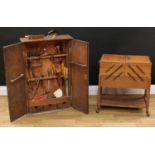 An oak bench top tool cabinet, enclosing an assortment of hand tools, including Stanley bull nose